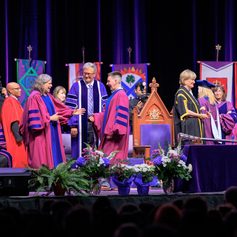 Graduates walking across the stage