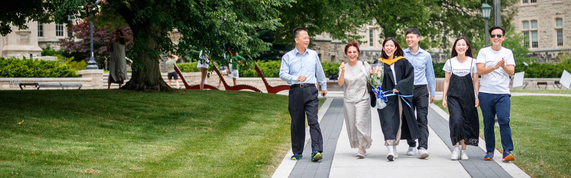 A group of graduates walking in front of University College