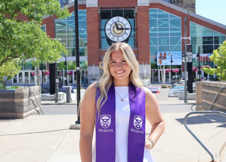 A graduate at Canada Life Place wearing an Alumni Stole