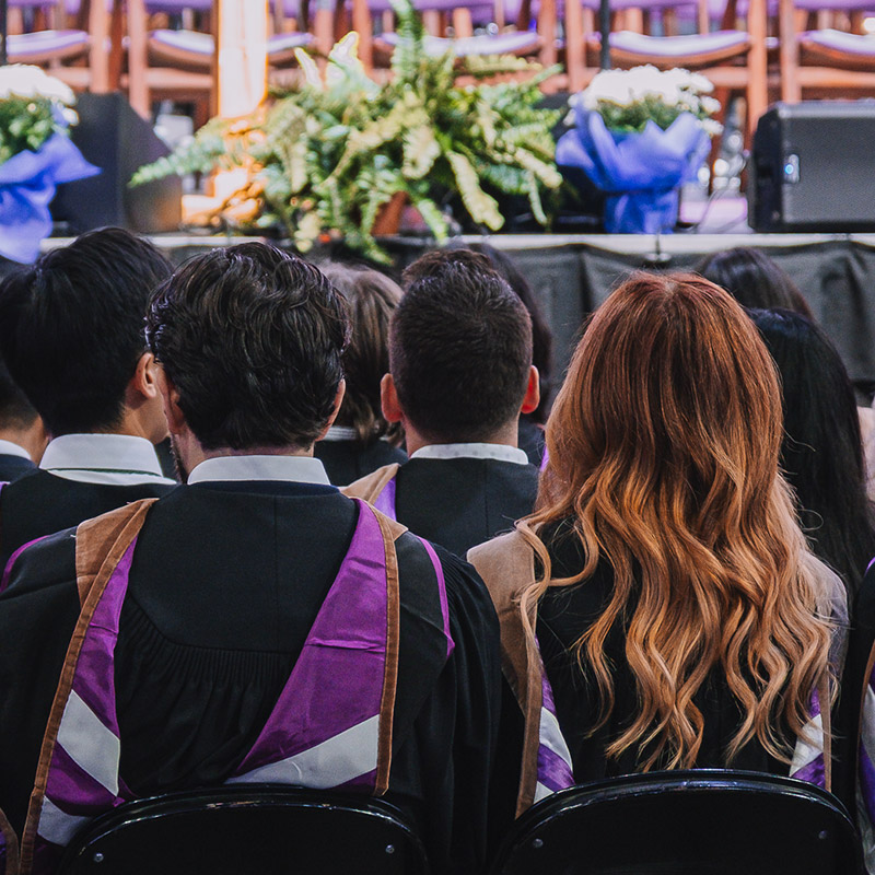 backs of students at convocation